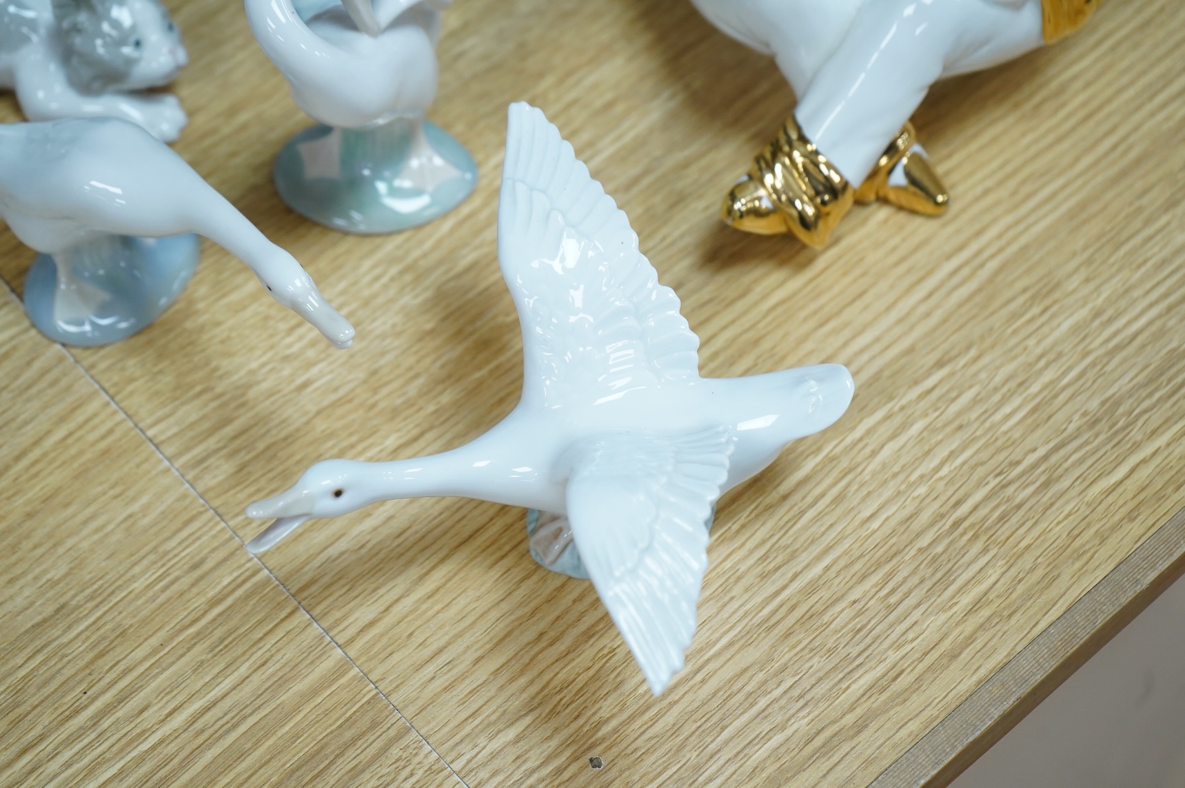 Two Doulton vases, a Casa Pupo pierrot dish and a collection of nine Lladro figures, largest 27cm high
